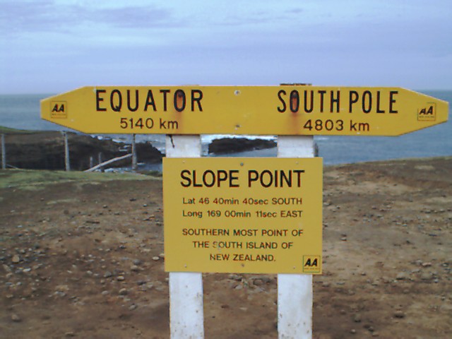 Close up of "The sign" at Slope Point (The Nugget is in the back gound.)
